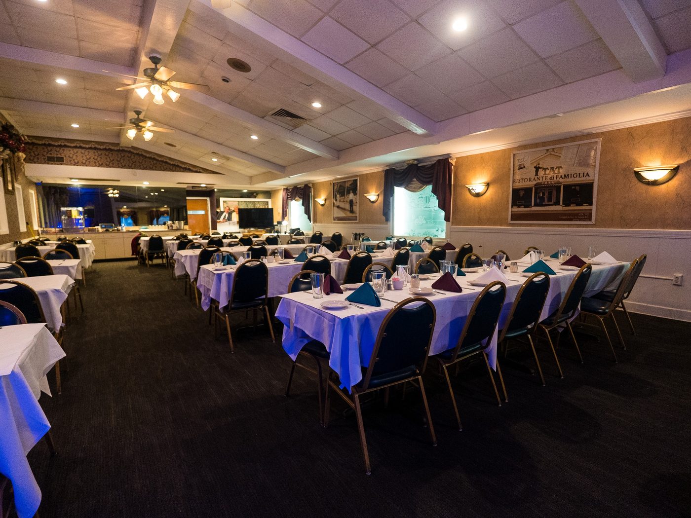 The banquet room with long tables set for a party