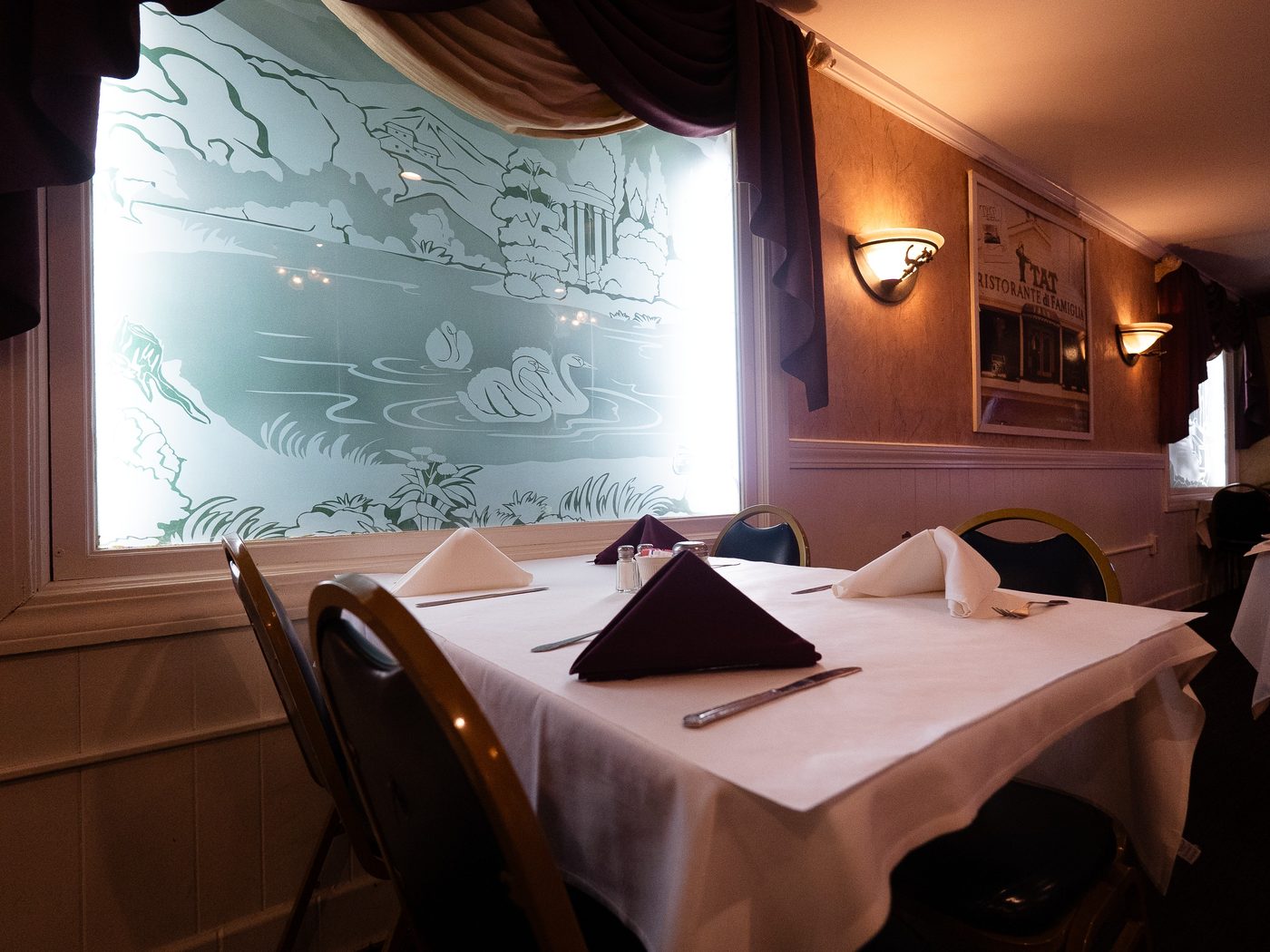 A table set by the etched-glass window