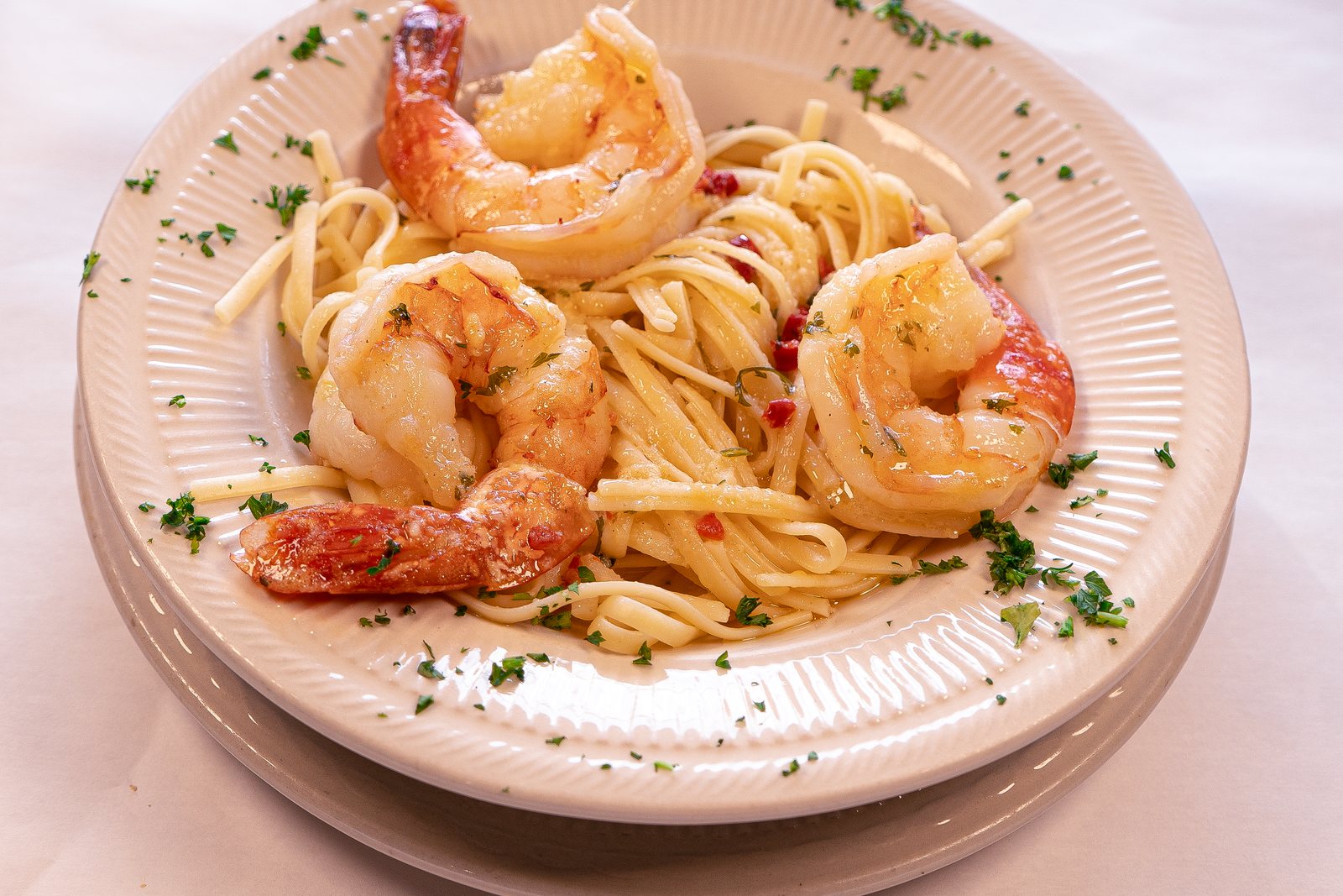 Shrimp scampi over linguine